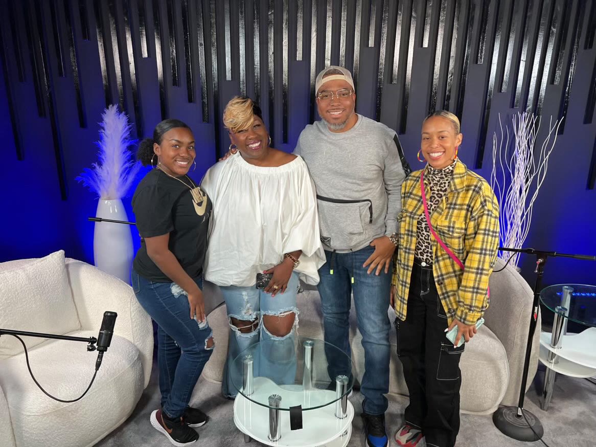 Jay.R Fogle with guests in a media studio